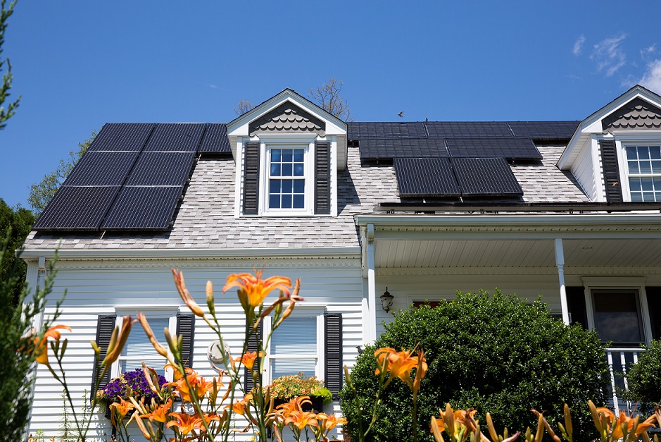 Solar panel installation on a nice cape house with sunny blue skies in the background