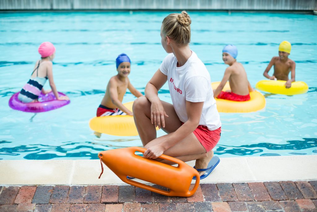 Lifeguard watching over kids in a pool 