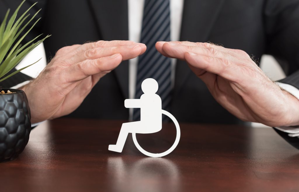 Insurer protecting a person with a disability with his hands