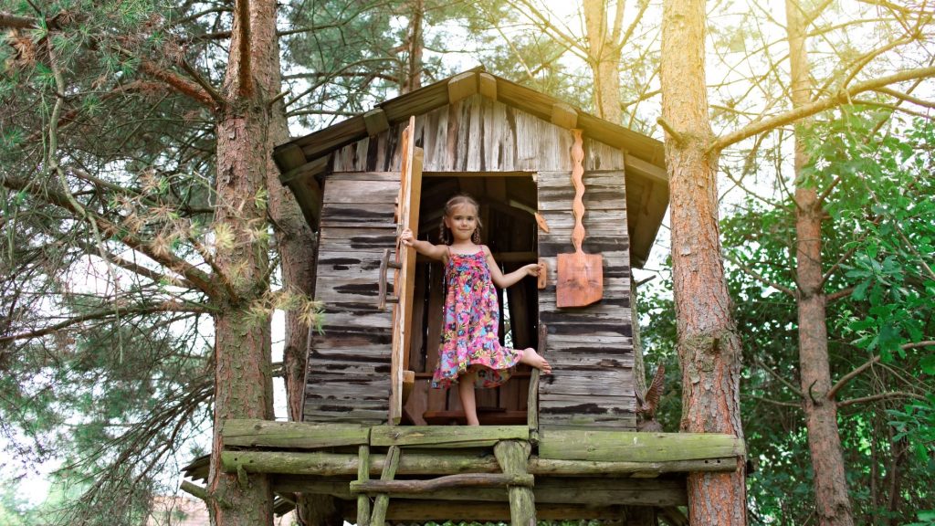 Girl playing in a tree house 