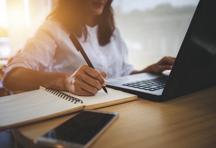 woman studying and taking notes 