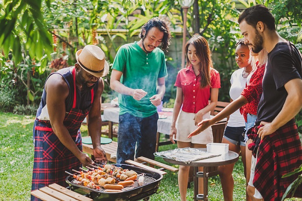 Group of people having barbecue/barbeque party at home