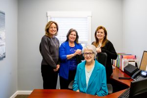 Jensen CSRs standing together in an office