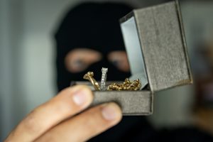 theif looking at wedding rings in a box